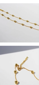 Macro detail of golden heart necklace showing the adjustable chain and lobster clasp