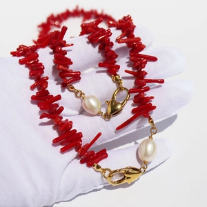 Irregular red coral branch necklace with teardrop pearls and gold heart clasp