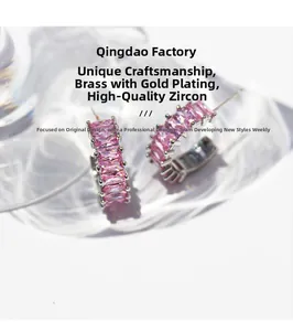 Detailed close-up of C-shaped hoop earrings with pink baguette-cut zircon in gold plating