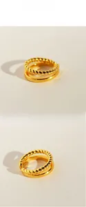 Detail of double-layered twisted rope and polished gold plated rings in stacked style