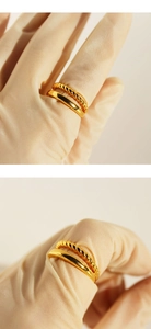 Detail of gold plated brass double-layer twisted rope and smooth minimalist rings set
