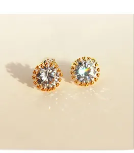 Close-up of gold-plated sunflower earrings featuring a large brilliant-cut cubic zirconia