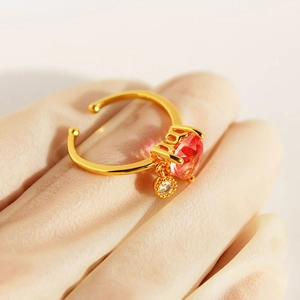 Adjustable gold open ring with a pink heart zircon and a small white pendant