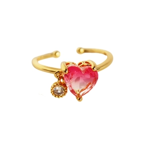 Adjustable golden ring with a heart-shaped pink zircon and a small crystal charm