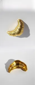 Detailed front and back view of a gold-plated croissant brooch with fine spiral texture
