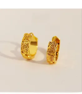 Detailed view of vintage brass gold-plated hoop earrings with intricate sunflower embossing