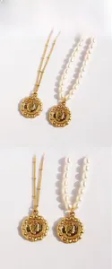 Detail of vintage portrait coin pendants on a gold chain and a freshwater pearl necklace