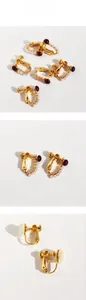 Detail of vintage red glass and pearl ear clips with adjustable gold-tone screw backings