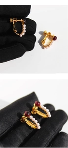 Macro shot of vintage U-shaped ear clips with red stone and delicate white pearls