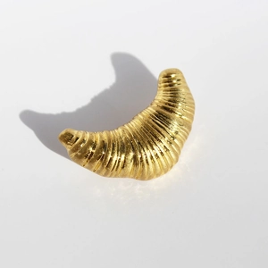 Gold plated croissant brooch with textured surface in minimalist design for outfits