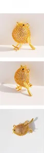 Macro views of gold bird brooch with pavé zircon, showing dual-use pendant details