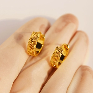 Vintage gold hoop earrings with embossed sunflower pattern and retro floral engraving