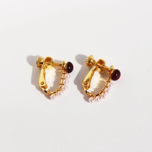 U-shaped gold clip-on earrings with red resin bead and white pearls for non-pierced ears