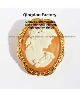 Close-up of vintage cameo brooch with 18k gold plated brass and zircon details