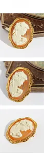 Detailed views of vintage cameo brooch with ivory profile relief and golden lace border