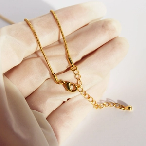 Gold snake chain necklace with glazed raspberry pearl and adjustable lobster clasp closure