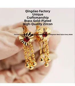 Detail of red heart zircon earring with gold-plated brass chain tassels and beads