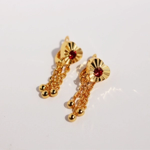 Golden heart earrings with red zircon, radial engraving, and dangling chain tassels
