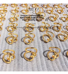 Detail view of gold-plated brass knotted rings featuring premium diamonds set on multiple layers