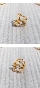 Close-up of gold layered irregular knot ring with polished finish and open adjustable band