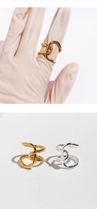 Detailed view of intertwined twisted rings in gold and silver with minimalist design