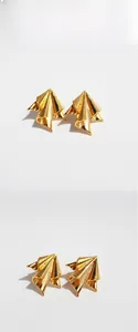 Detailed view of gold irregular crinkled metal earrings with textured brushed finish