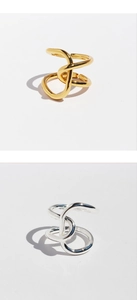 Detailed view of intertwined gold and silver knot rings with modern artistic design