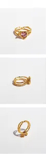 Detailed views of gold heart ring featuring pink zircon and lava texture double bands