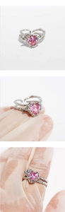 Detail of pink heart zircon ring with textured silver double-layer interlaced band