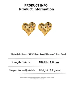 Detailed specs of gold heart earrings with molten lava texture and zircon inlay
