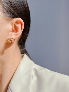 Detail of luxury geometric knot earrings with zircon pavé setting on gold base