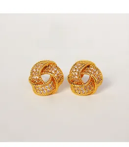 Close-up of gold plated brass knot earrings with micro-set sparkling zircon stones
