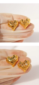 Macro detail of gold molten lava texture heart earrings with sparkling cubic zirconia