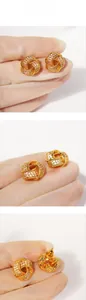 Macro shot of gold-plated knot earrings with micro-paved cubic zirconia details