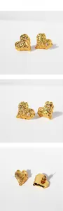 Macro detail of molten texture gold heart earrings with sparkling cubic zirconia stones