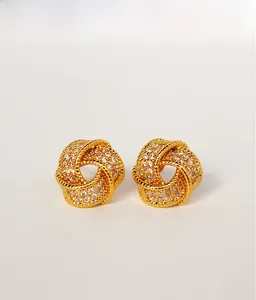 Detail presentation of gold knot earrings with micro-pave white crystals for women