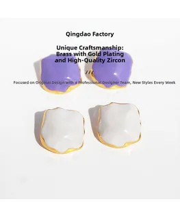 Detail view of purple and white enamel geometric earrings with brass gold plating