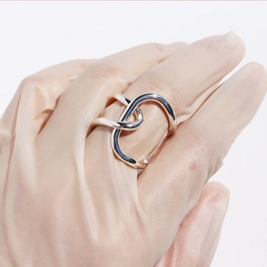 Minimalist silver irregular knotted adjustable ring with a polished intertwined line design