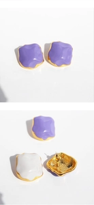 Detail of irregular geometric enamel earrings showing purple finish and textured metal back