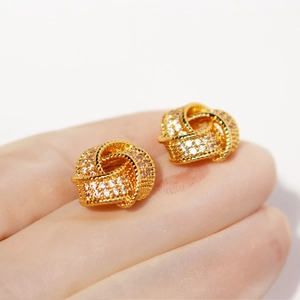 Luxe gold-plated knot stud earrings encrusted with sparkling zircon stones