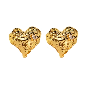 Golden heart-shaped lava metal earrings with zircon accents and textured surface