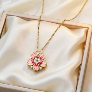 Elegant gold cherry blossom necklace with pink petals and small crystals on champagne silk