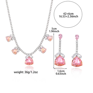 Pink cubic zirconia jewelry set with silver necklace and teardrop earrings on white background