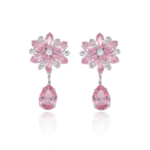 Pink zircon flower earrings set with teardrop crystals on white reflective background