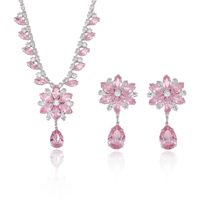 Fashionable pink zircon flower jewelry set with necklace and earrings on white mirror base