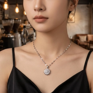 Elegant rotating bauhinia flower pendant necklace in silver with sparkling zircons