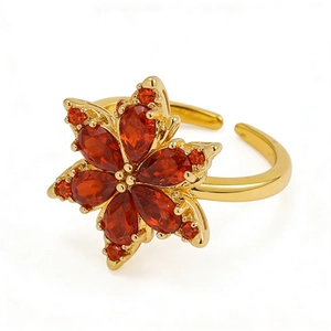 Adjustable gold flower ring featuring red pear-cut gemstones and a minimalist design