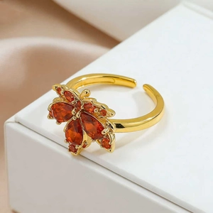 Adjustable maple leaf open ring in gold with sparkling orange and red gemstones