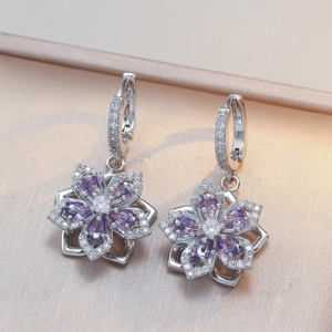 Detailed macro view of S925 silver flower earrings with purple and white cubic zirconia