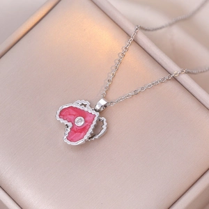Detail of pink enamel Africa map pendant necklace with zircon inlay on silk texture